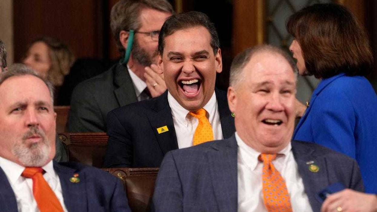 Rep. George Santos (R-NY) (C) laughs before U.S. President Joe Biden delivers the State of the Union address to a joint session of Congress on February 7, 2023 in the House Chamber of the U.S. Capitol in Washington, DC. The speech marks Biden's first address to the new Republican-controlled House. (Photo by Jacquelyn Martin-Pool/Getty Images)