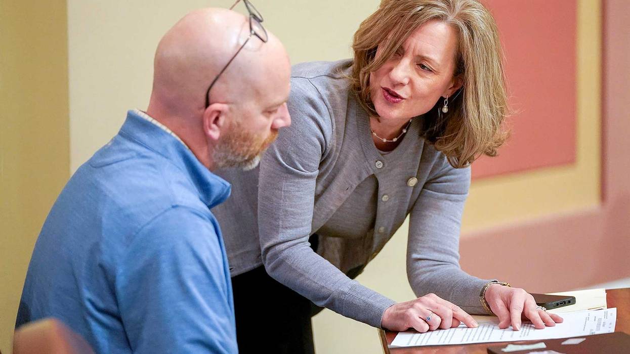 Rep. Kristin Robbins confers with Rep. Brad Tabke during a floor session March 14.