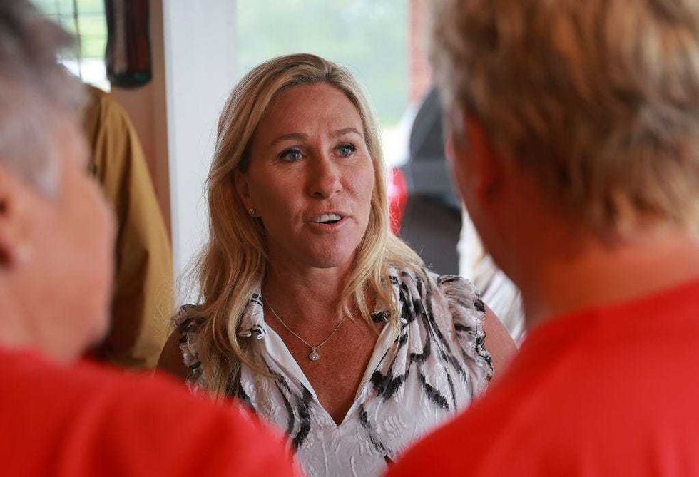 Rep. Marjorie Taylor Greene (R-GA) interacts with voters during a campaign stop at the Creme Hut on May 23, 2022 in Chatsworth, Georgia. Rep. Greene is running for a second congressional term in the state