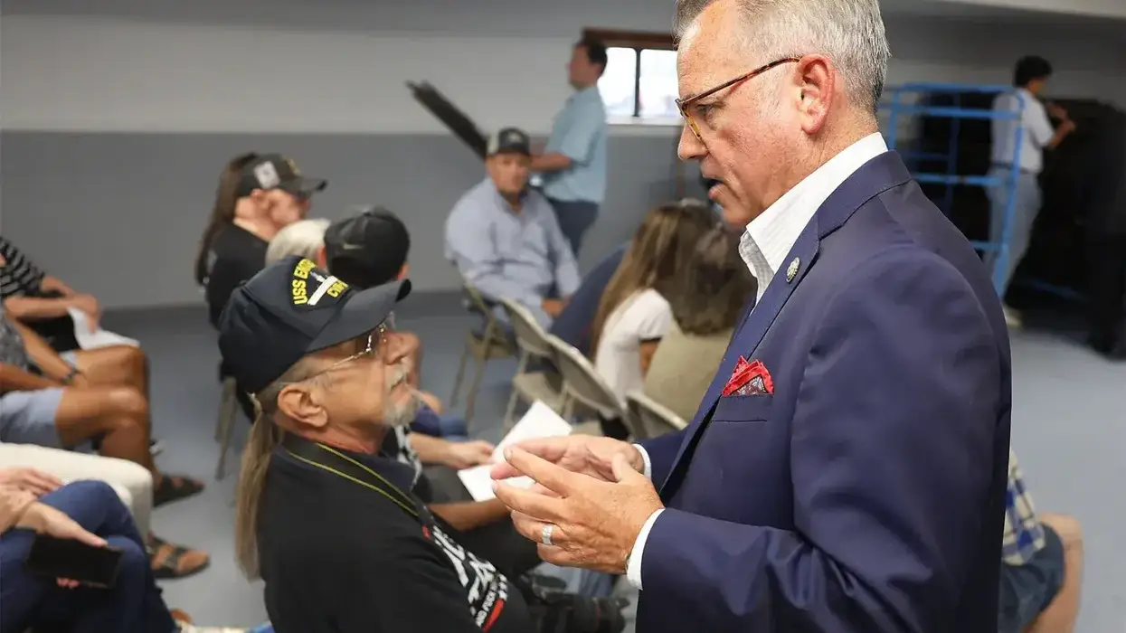 Rep. Mark Alford, right, introduces himself to Douglas Walther, left, before the town hall on Wednesday at the Lions Club in Harrisburg.