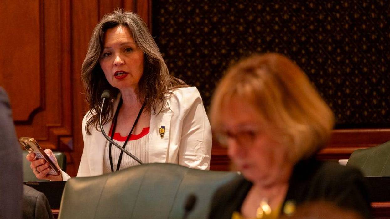 Rep. Nicolle Grasse, D-Arlington Heights, speaks during debate over a bill legalizing medically assisted suicide. She looks at bill sponsor Rep. Robyn Gabel, D-Evanston, pictured in the foreground.