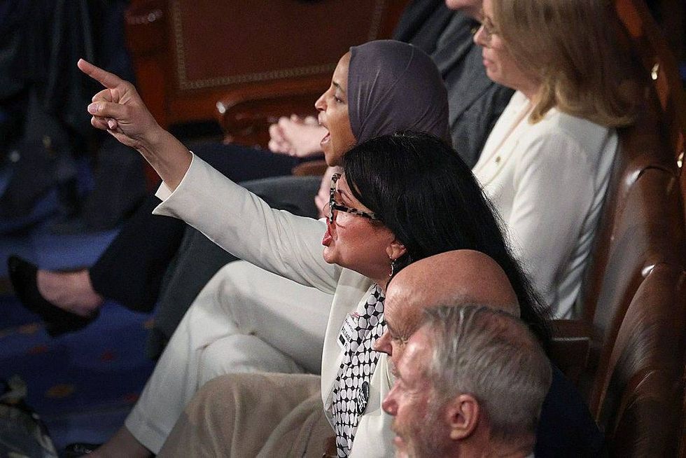 Rep. Rashida Tlaib (D-MI) and Rep. Ilhan Omar (D-MI) shout during U.S. President Donald Trump