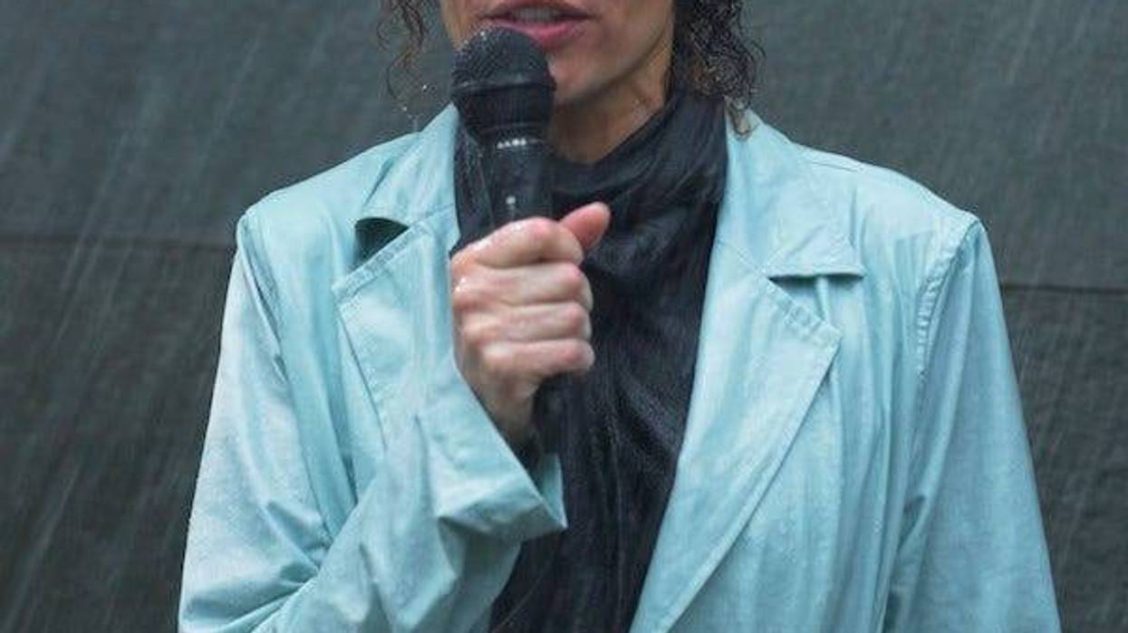 Reporter talking into microphone in the middle of a rainstorm