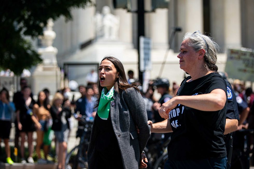 Representative Alexandria Ocasio-Cortez, a Democrat from New York, is arrested outside the US Supreme Court during a protest of the court overturning Roe v. Wade in Washington, D.C., US, on Tuesday, July 19, 2022