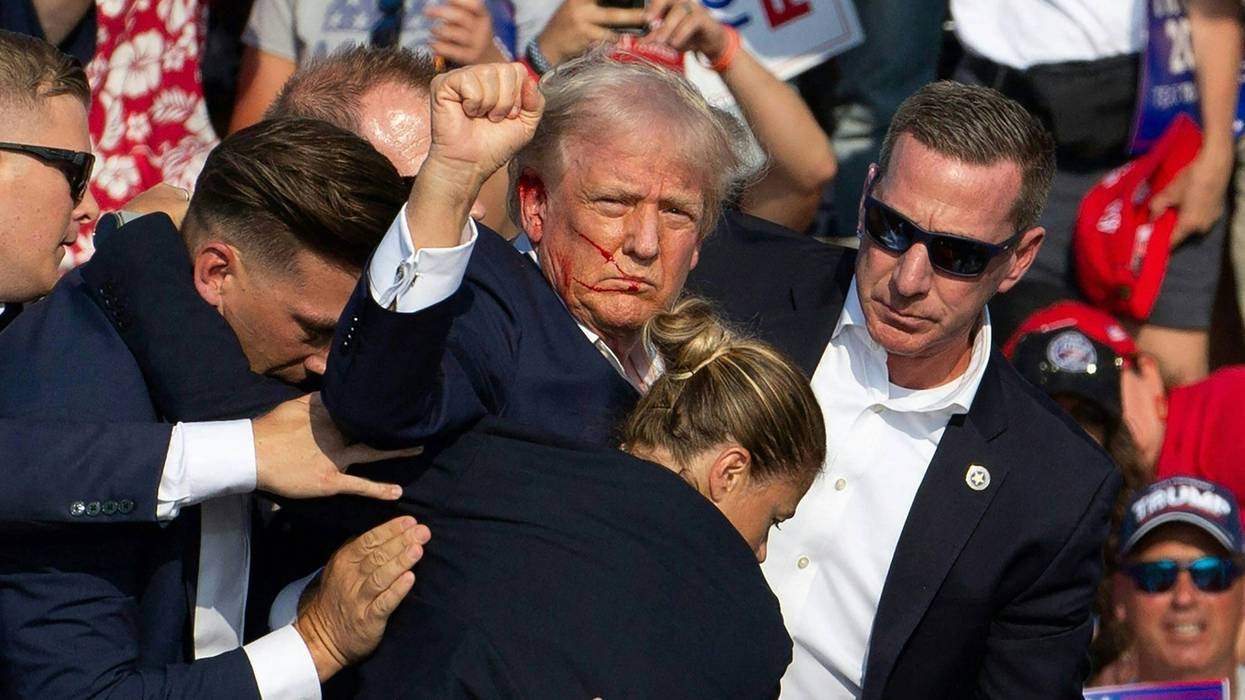 Republican candidate Donald Trump is seen with blood on his face surrounded by Secret Service agents as he is taken off the stage at a campaign event at Butler Farm Show Inc. in Butler, Pennsylvania, July 13, 2024.