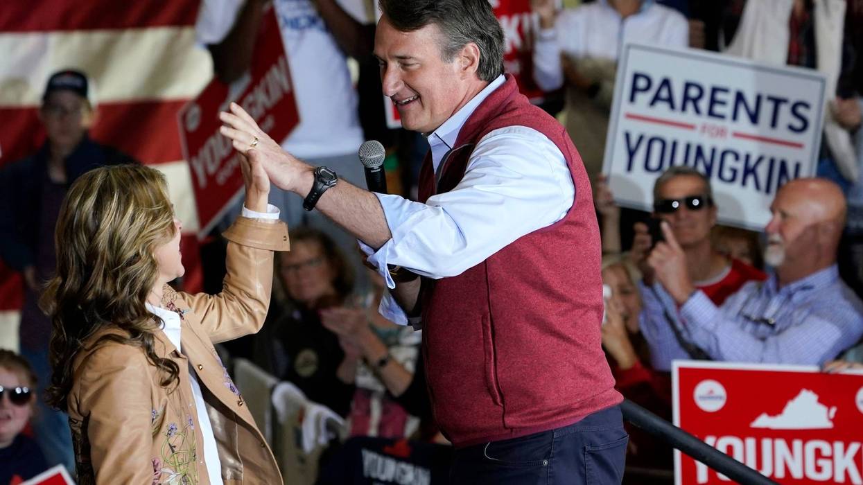 Republican gubernatorial candidate Glenn Youngkin, right, gives his wife Suzanne, a high five during a rally in Chesterfield, Va., Monday, Nov. 1, 2021. Youngkin will face Democrat former Gov. Terry McAuliffe in the November election.