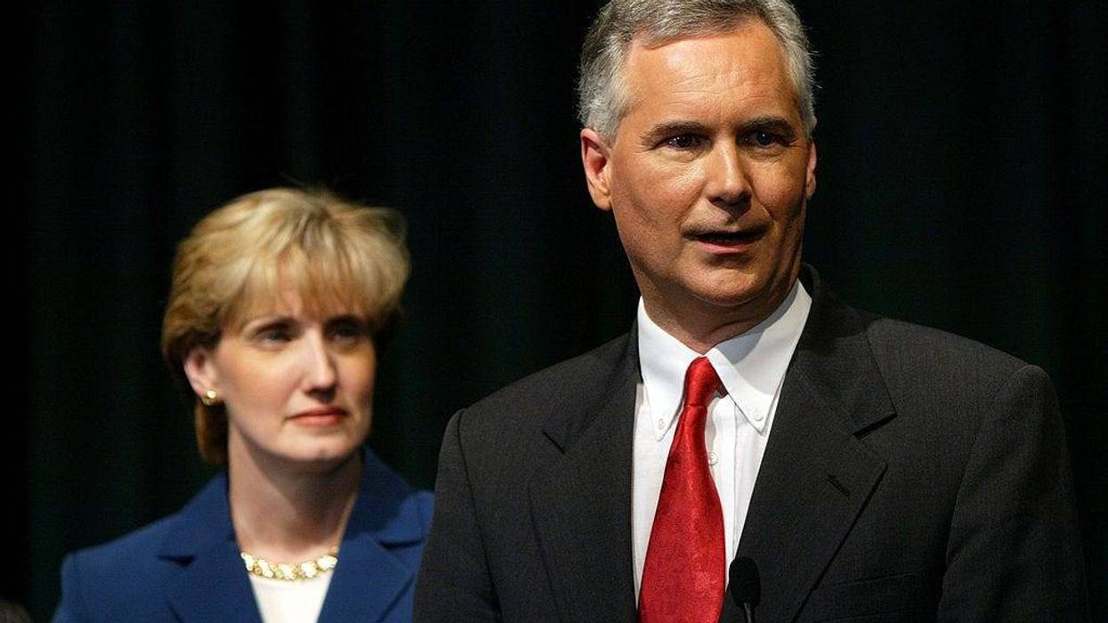 Republican gubernatorial candidate Tom McClintock speaks to reporters with his wife Lori after participating in a denate at California State University, Sacramento September 24, 2003 in Sacramento, California.