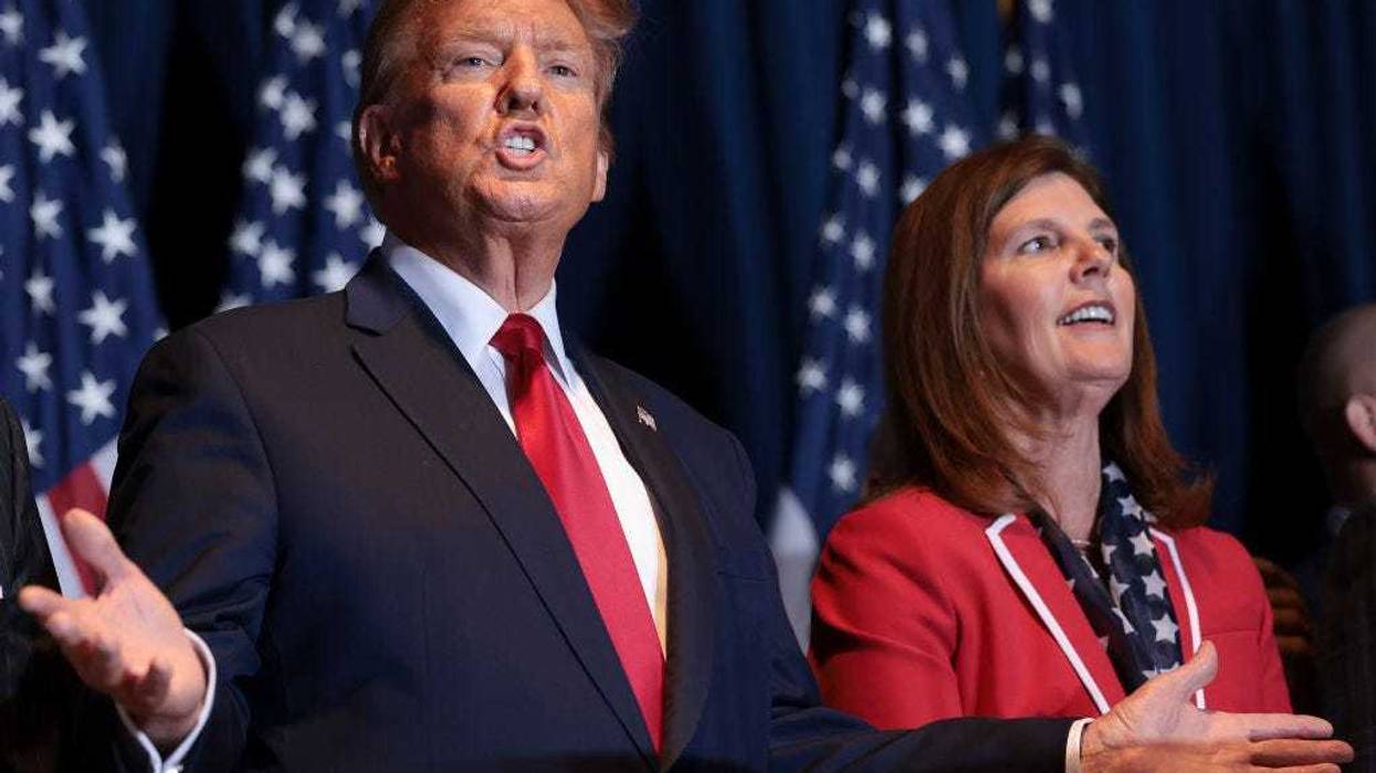 Republican presidential candidate and former President Donald Trump gestures to supporters at an election night watch party at the State Fairgrounds on February 24, 2024 in Columbia, South Carolina. Trump defeated Republican presidential candidate former U.N. Ambassador Nikki Haley in her home state as South Carolina held its primary today. Also pictured is South Carolina Lieutenant Governor Pamela Evette (R).