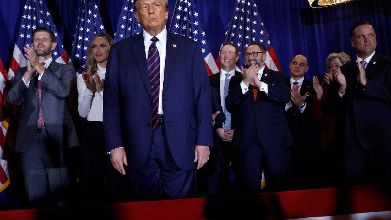 Republican presidential candidate and former U.S. President Donald Trump (C) takes the stage with supporters, campaign staff and family members for a primary night party at the Sheraton on January 23, 2024 in Nashua, New Hampshire.