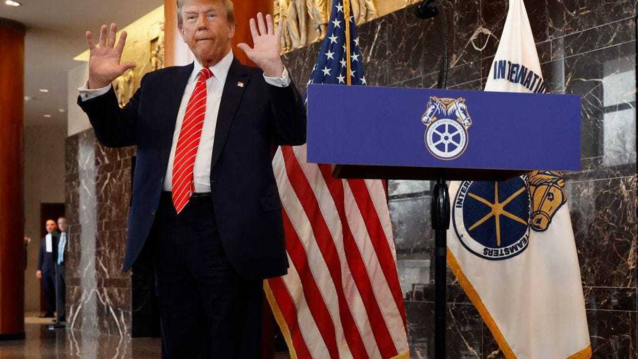Republican presidential candidate and former U.S. President Donald Trump holds up his hands after being asked about them by reporters at the International Brotherhood of Teamsters headquarters on January 31, 2024 in Washington, DC. Trump met with leaders and members of the organized labor group while looking for union support after the United Auto Workers endorsed President Joe Biden's re-election campaign one week ago.