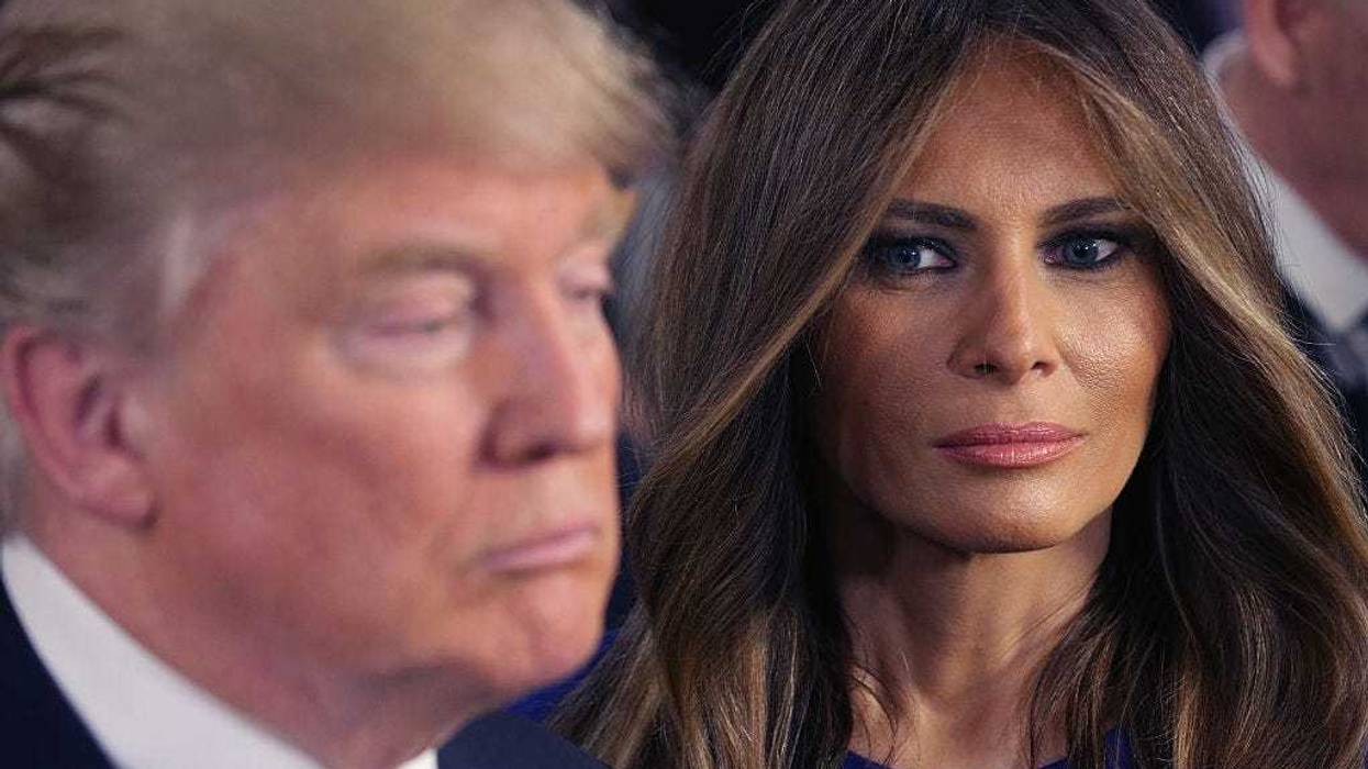 Republican presidential candidate Donald Trump and his wife Melania greet reporters in the spin room following a debate sponsored by Fox News at the Fox Theatre on March 3, 2016 in Detroit, Michigan. Voters in Michigan will go to the polls March 8 for the State's primary. (Photo by Chip Somodevilla/Getty Images)