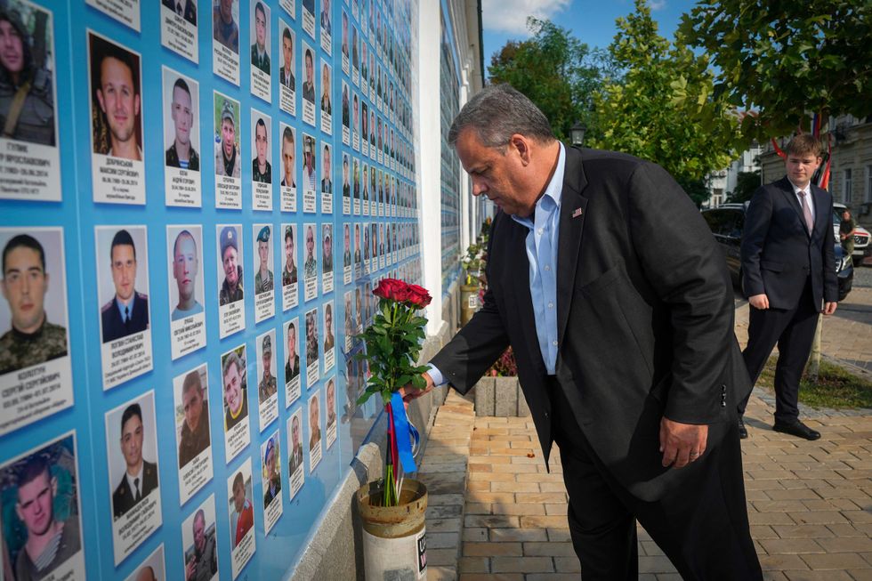 Republican presidential candidate former New Jersey Gov. Chris Christie lays flowers at the Wall of Remembrance to pay tribute to killed Ukrainian soldiers, Kyiv, Ukraine, Friday, Aug. 4, 2023