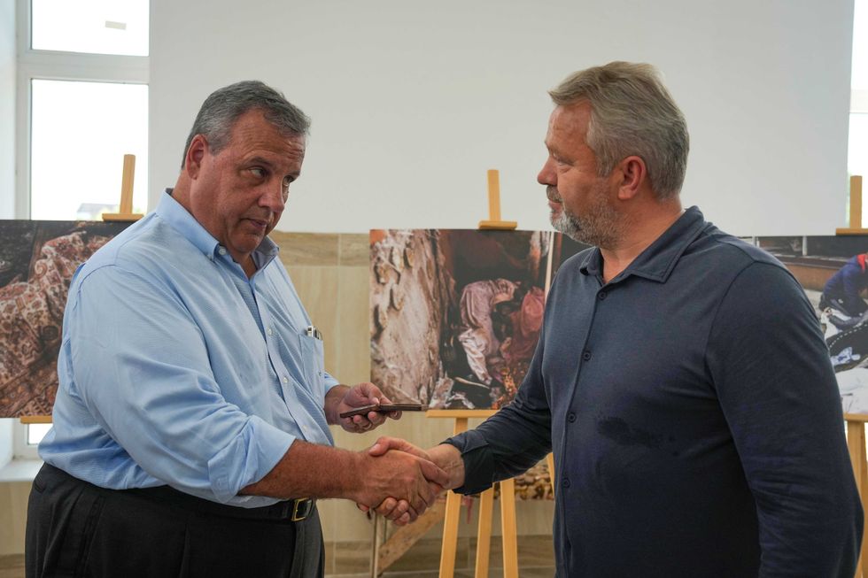 Republican presidential candidate former New Jersey Gov. Chris Christie, left, shakes hands with Bucha Mayor Anatoly Fedoruk, right, in the Church of the St. Andrew and All Saints in Bucha, on the outskirts of Kyiv, Ukraine, Friday, Aug. 4, 2023.
