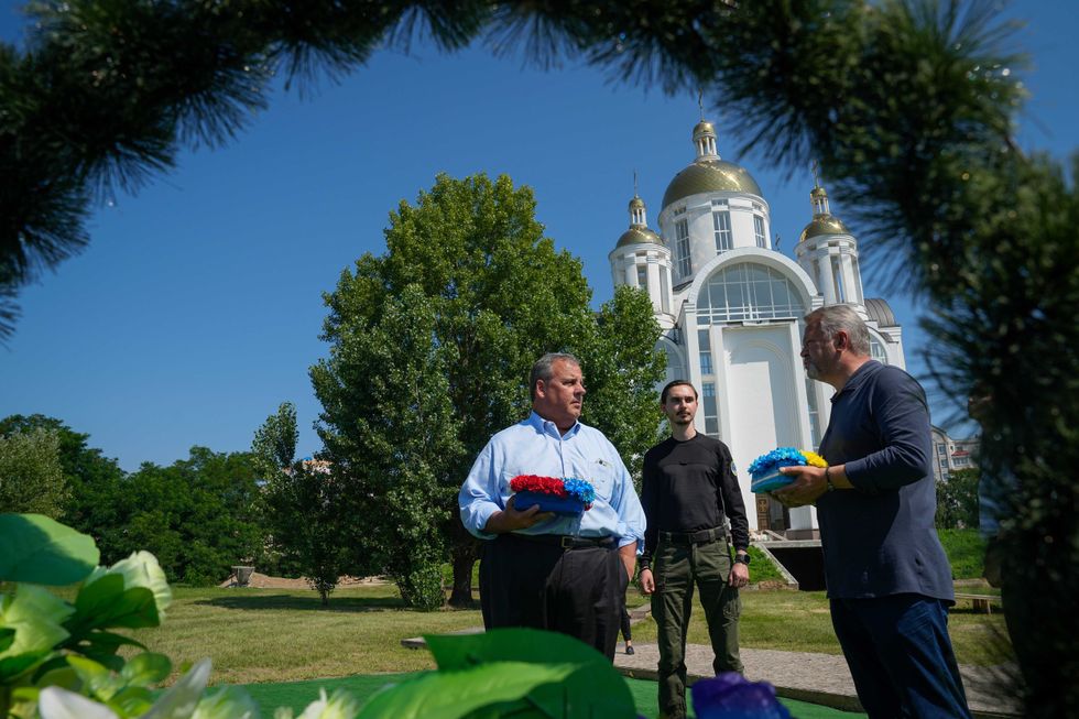 Republican presidential candidate former New Jersey Gov. Chris Christie participates in a flowers laying ceremony near St. Andrew