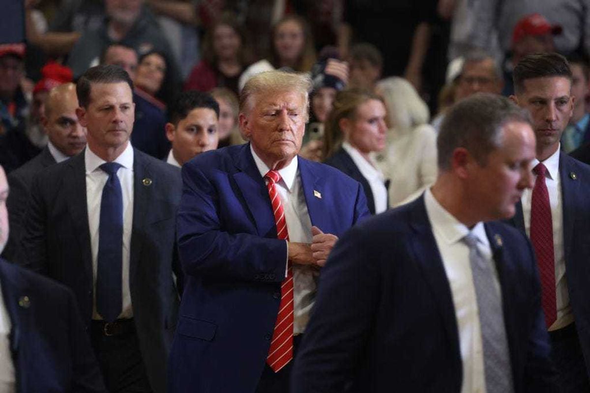 Republican presidential candidate former President Donald Trump greets guests as he wraps up a rally at Clinton Middle School on January 06, 2024 in Clinton, Iowa.