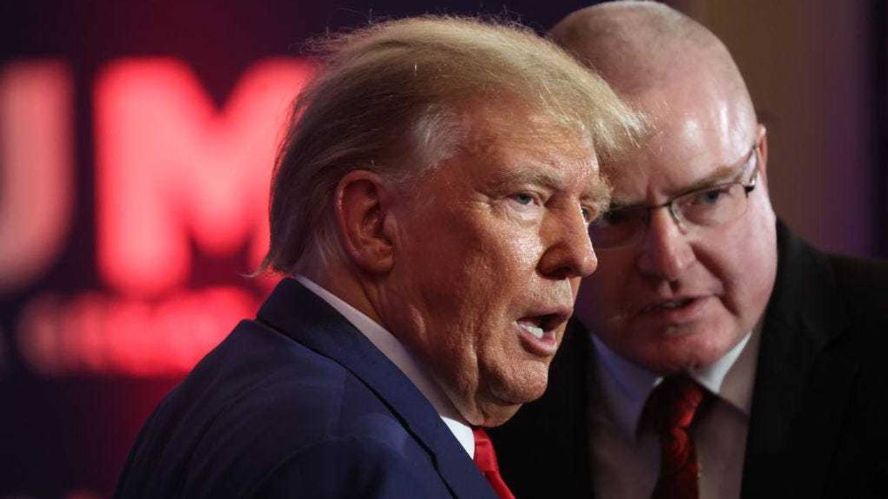 Republican presidential candidate former President Donald Trump greets guests at the Republican Party of Iowa 2023 Lincoln Dinner on July 28, 2023 in Des Moines, Iowa. Thirteen Republican presidential candidates were scheduled to speak at the event. (Photo by Scott Olson/Getty Images)