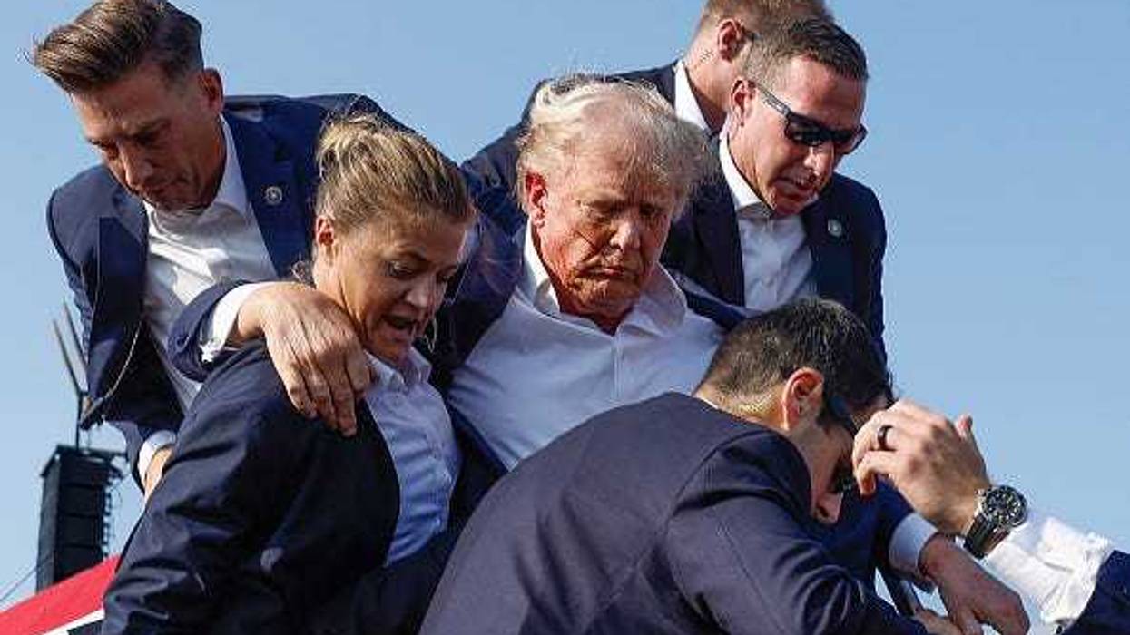Republican presidential candidate former President Donald Trump is rushed offstage by U.S. Secret Service agents after being grazed by a bullet during a rally on July 13, 2024 in Butler, Pennsylvania.