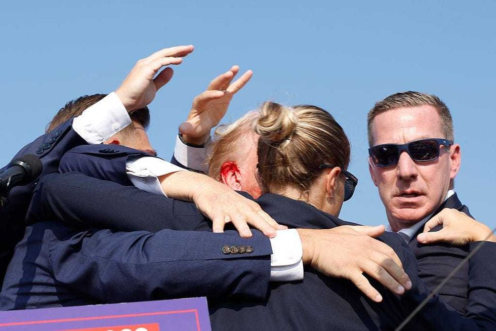 Republican presidential candidate former President Donald Trump is rushed offstage during a rally on July 13, 2024 in Butler, Pennsylvania. Butler County district attorney Richard Goldinger said the shooter is dead after injuring former U.S. President Donald Trump, killing one audience member and injuring another in the shooting. (Photo by Anna Moneymaker/Getty Images)