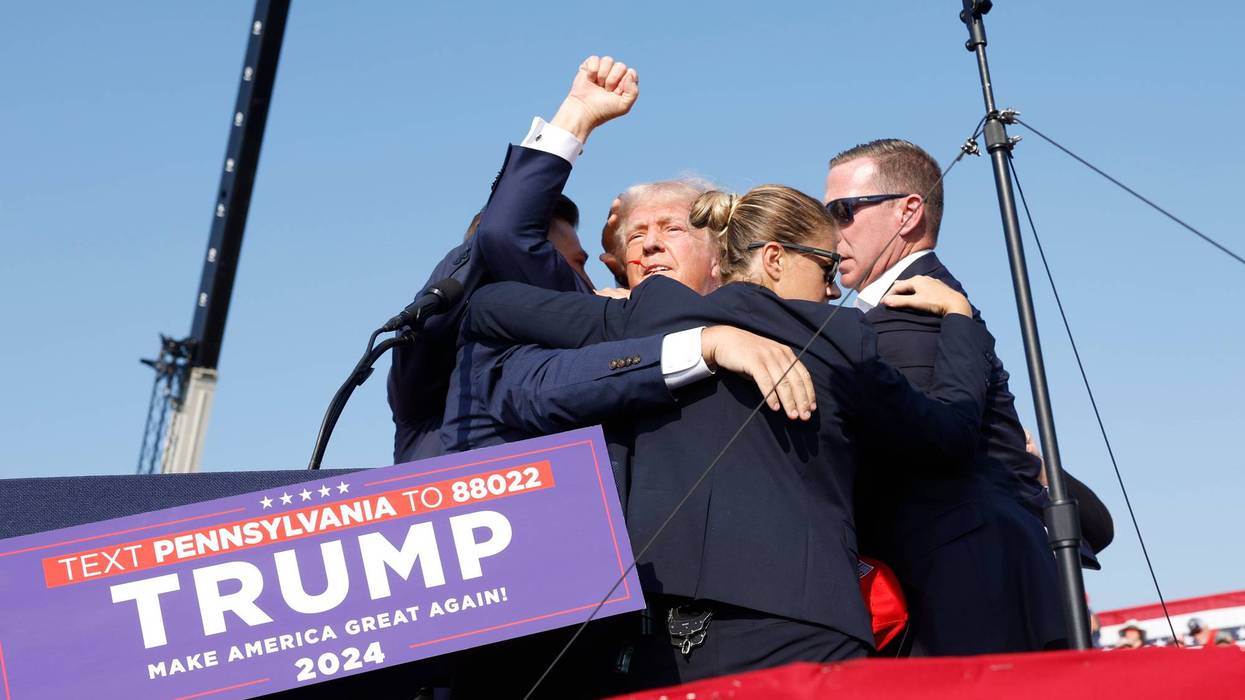 Republican presidential candidate former President Donald Trump is rushed offstage during a rally on July 13, 2024 in Butler, Pennsylvania. Butler County district attorney Richard Goldinger said the shooter is dead after injuring former U.S. President Donald Trump, killing one audience member and injuring another in the shooting.