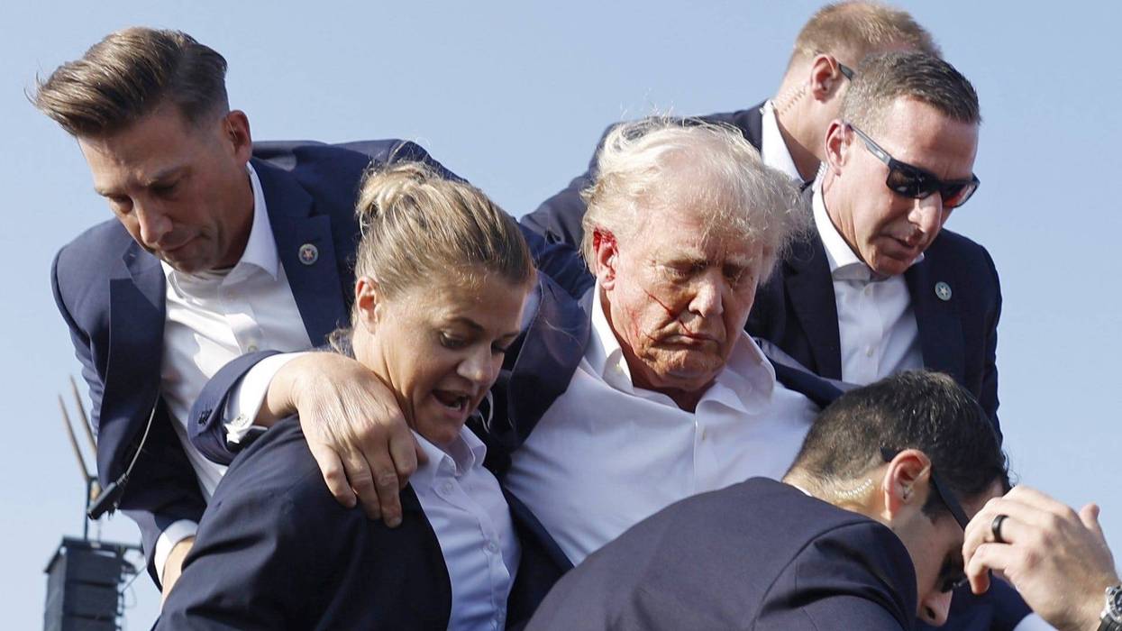 Republican presidential candidate former President Donald Trump is rushed offstage during a rally on July 13, 2024 in Butler, Pennsylvania. Butler County district attorney Richard Goldinger said the shooter is dead after injuring former U.S. President Donald Trump, killing one audience member and injuring another in the shooting.