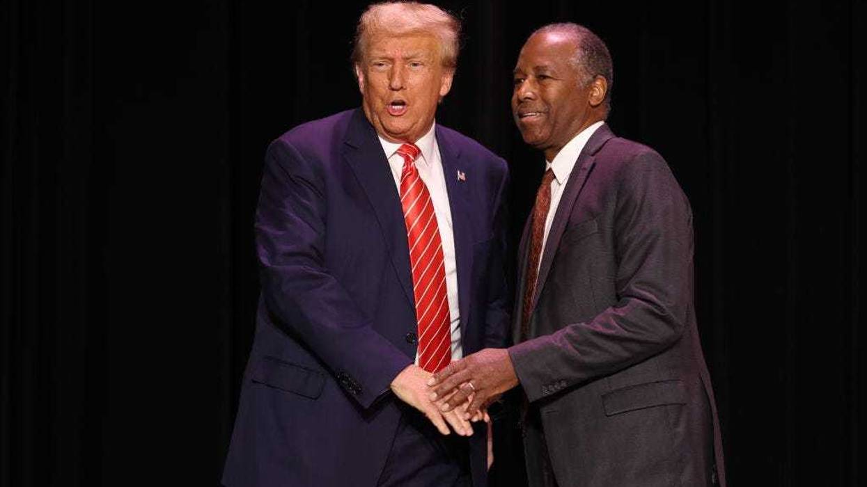 Republican presidential candidate former U.S. President Donald Trump greets former HUD Secretary Ben Carson during a campaign event where he received Carson's endorsement on October 29, 2023 in Sioux City, Iowa. On Saturday, Trump joined other Republican presidential candidates when he addressed Republican Jewish Coalition’s annual conference where his one-time vice president, Mike Pence, announced he was suspending his campaign. (Photo by Scott Olson/Getty Images)