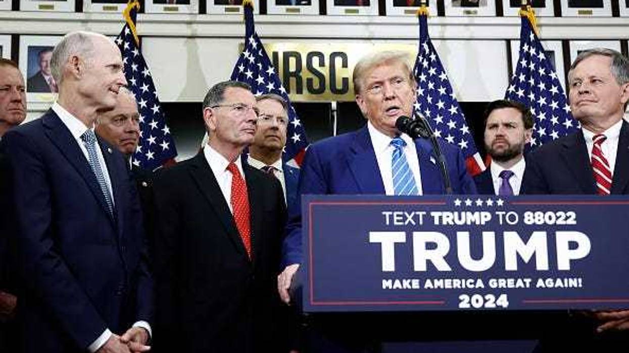 Republican presidential candidate, former U.S. President Donald Trump, is flanked by Senate Republicans as he gives remarks to the press at the National Republican Senatorial Committee building on June 13, 2024 in Washington, DC.