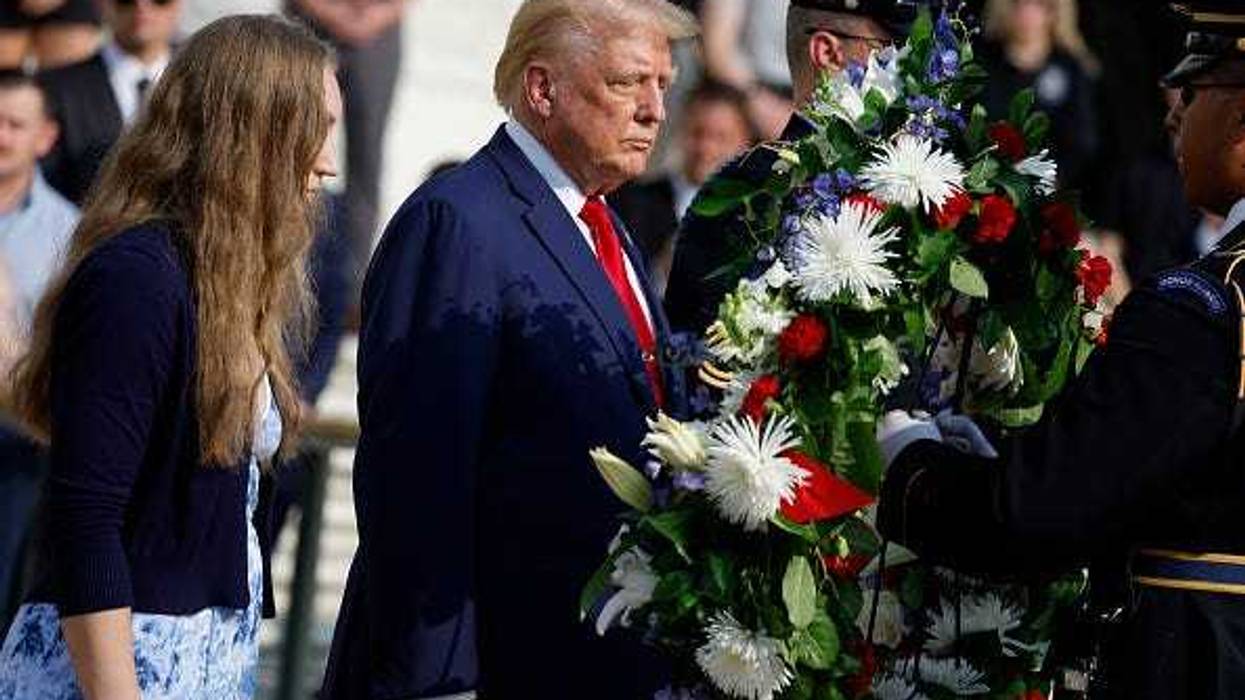 Republican presidential nominee, former U.S. President Donald Trump stands alongside Misty Fuoco, whose sister Sgt. Nicole Gee died in Abbey Gate Bombing, at a wreath laying ceremony at the Tomb of the Unknown Soldier at Arlington National Cemetery on August 26, 2024 in Arlington, Virginia.