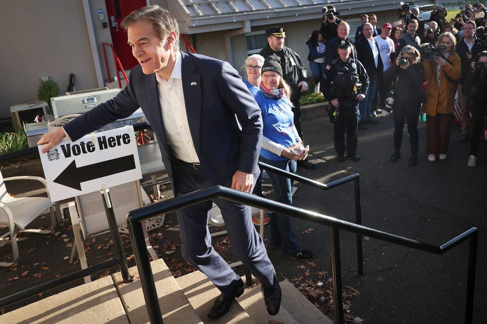 Republican U.S. Senate candidate Dr. Mehmet Oz enters the polling station at the Bryn Athyn Borough Hall to cast his ballot on Nov. 8, 2022, in Huntingdon Valley, Pennsylvania. Oz faces Democratic Pennsylvania Senate nominee John Fetterman in midterm elections taking place across the United States.