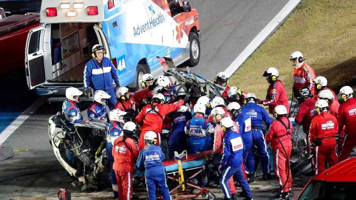 Rescue workers remove Ryan Newman from his car after he was involved in a wreck on the last lap of the NASCAR Daytona 500