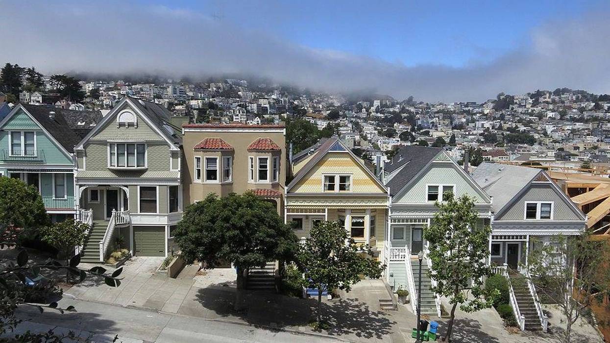Residential houses line a street in Mission district near Delores Park as typical summer fog rolls in on July 4, 2014 in San Francisco, California.