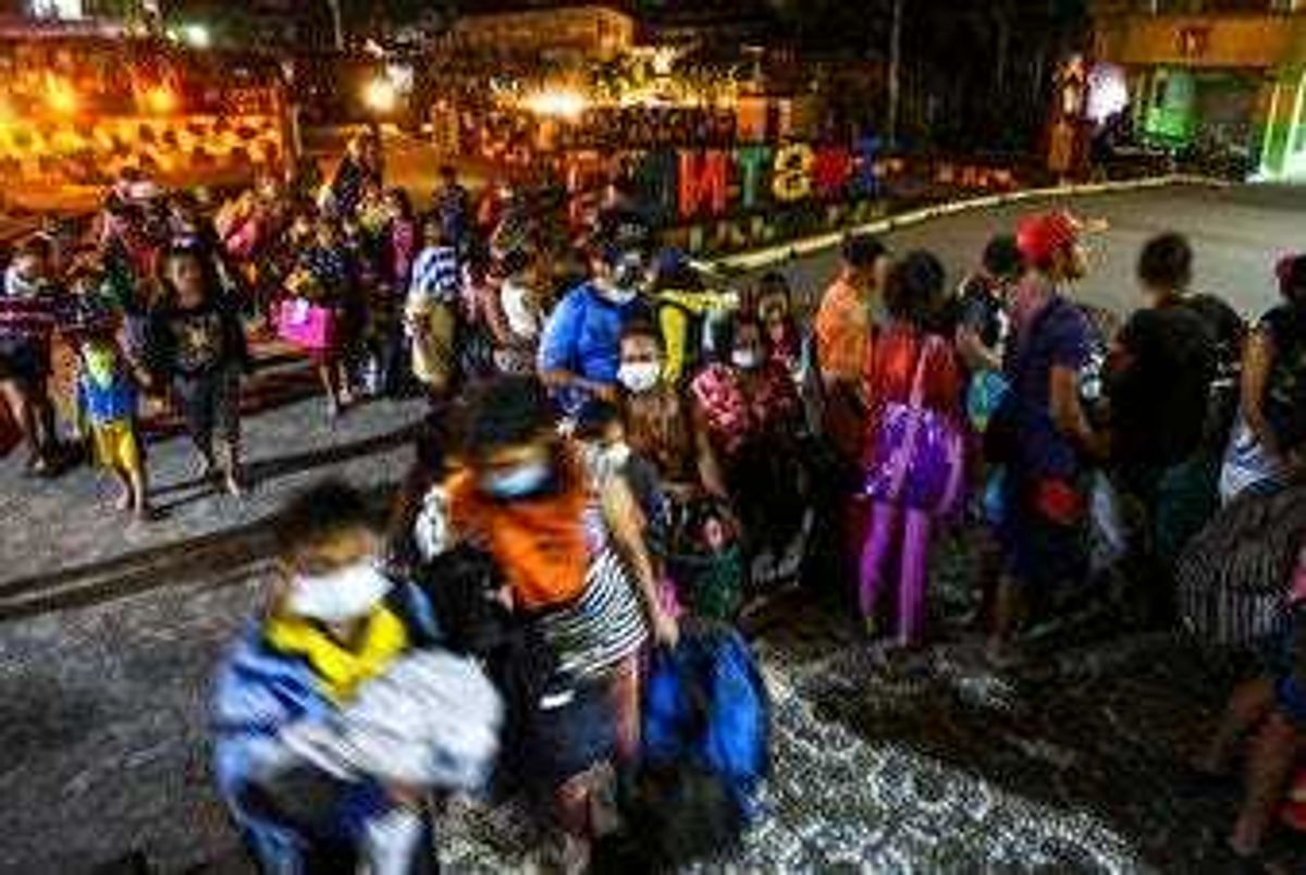 Residents are evacuated to a local school as the Taal volcano continues to erupt in Santo Tomas, Batangas, southern Philippines, Monday January 13, 2020. (AP Photo/Gerrard Carreon)