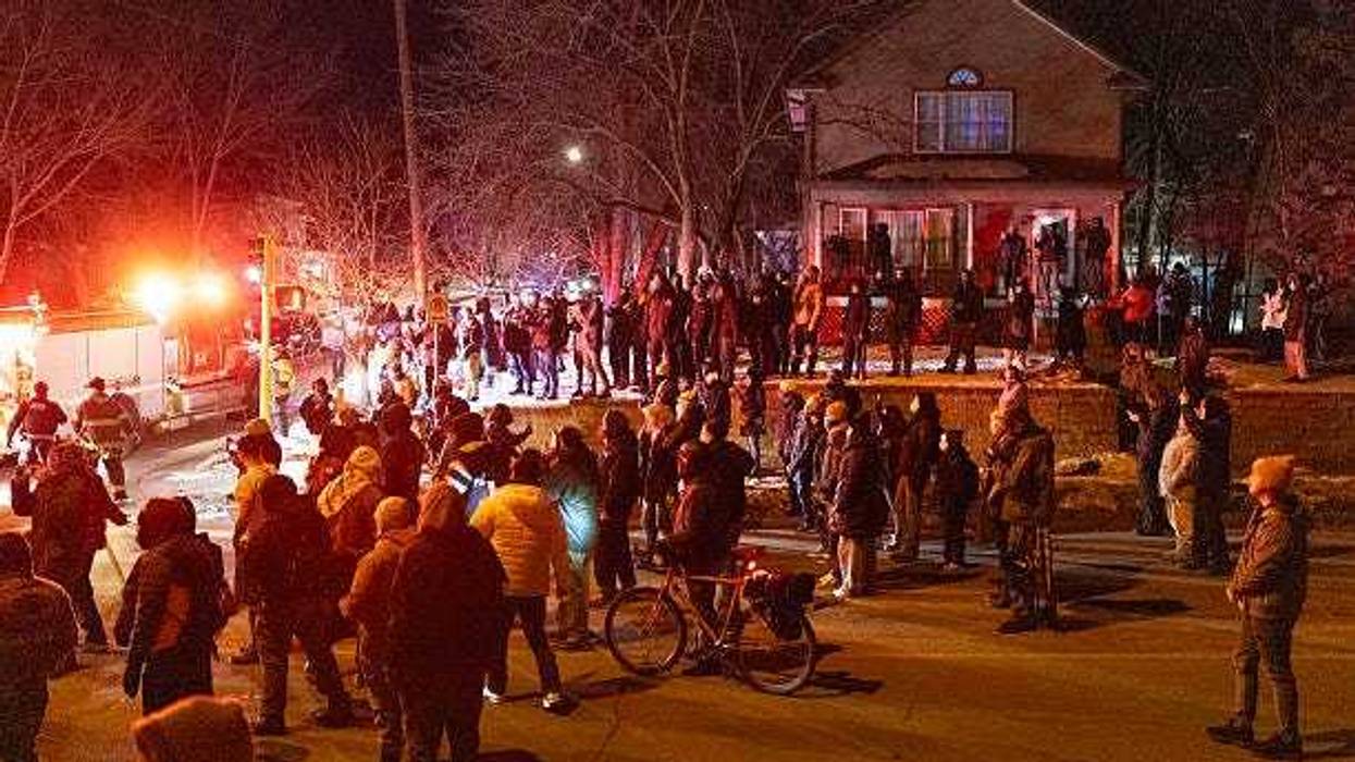 Residents confront federal agents following a shooting incident on January 14, 2026 in Minneapolis, Minnesota. According to reports, a federal agent shot a Venezuelan man who was resisting arrest.