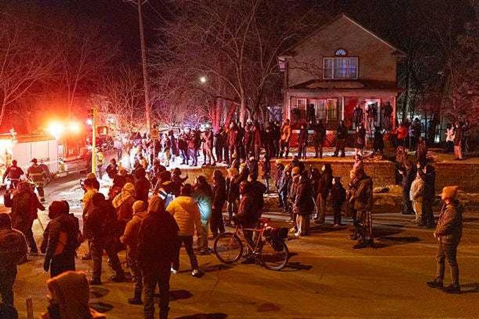 Residents confront federal agents following a shooting incident on January 14, 2026 in Minneapolis, Minnesota. According to reports, a federal agent shot a Venezuelan man who was resisting arrest.