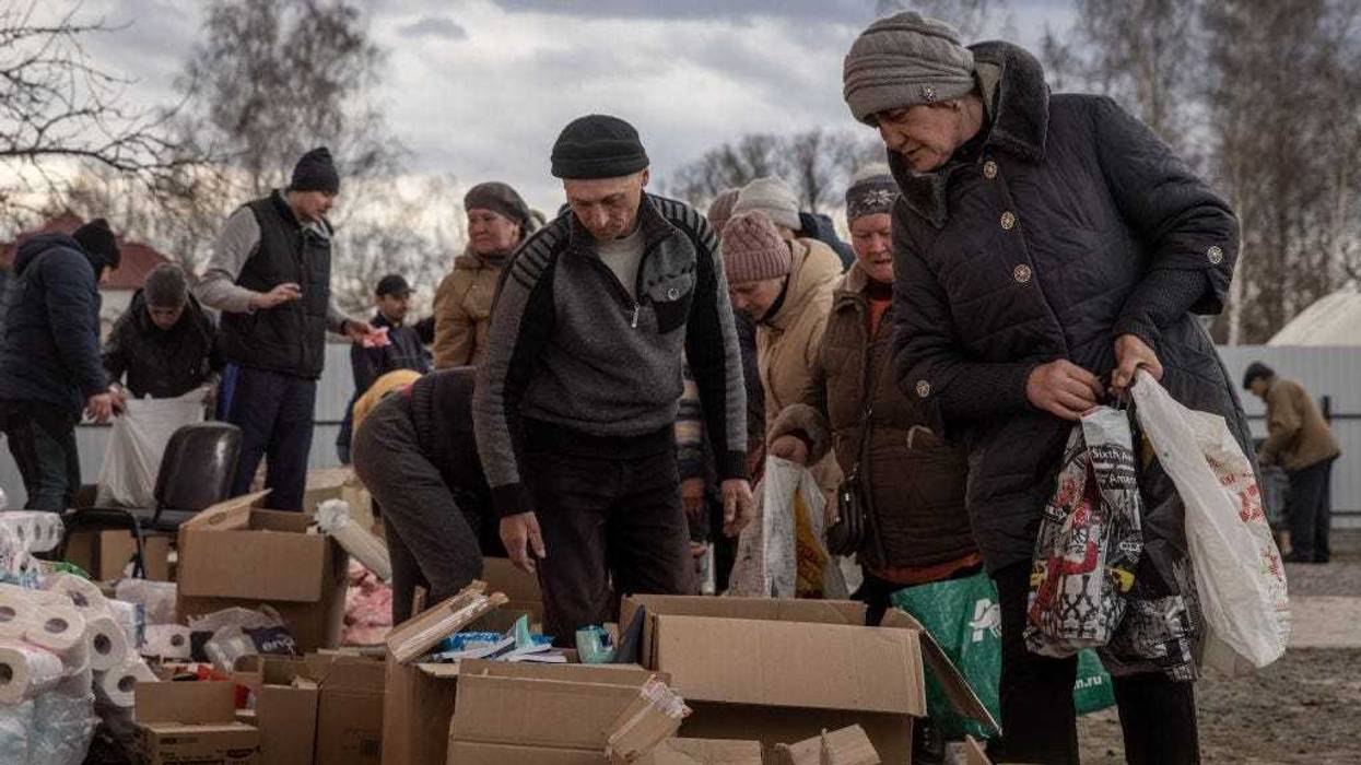 Residents line up to collect food aid at a humanitarian aid station on March 29, 2022 in Trostyanets, Ukraine.