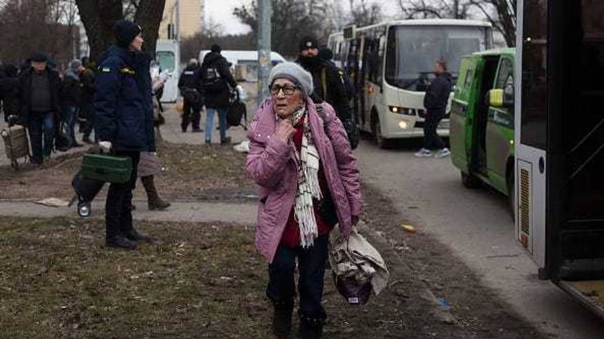 Residents of Irpin who evacuated wait to get seated in the buses to go further on March 6, 2022 in Kyiv, Ukraine.