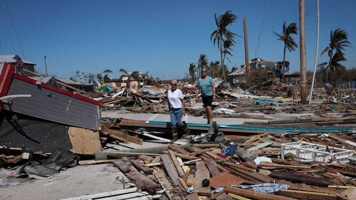 Residents of Pine Island walk amongst the wreckage left in the wake of Hurricane Ian on the island of Matlacha on September 30, 2022 in Matlacha, Florida.