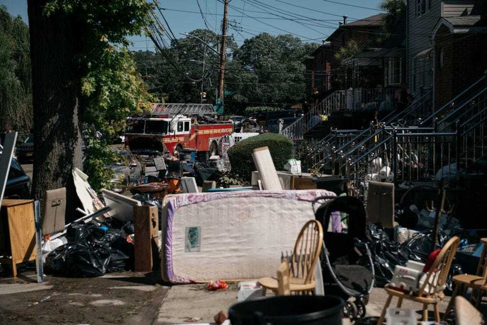 Residents sort through damaged and destroyed items after a night of heavy rain and wind caused many homes to flood on September 2, 2021 in the Flushing neighborhood of the Queens borough of New York City
