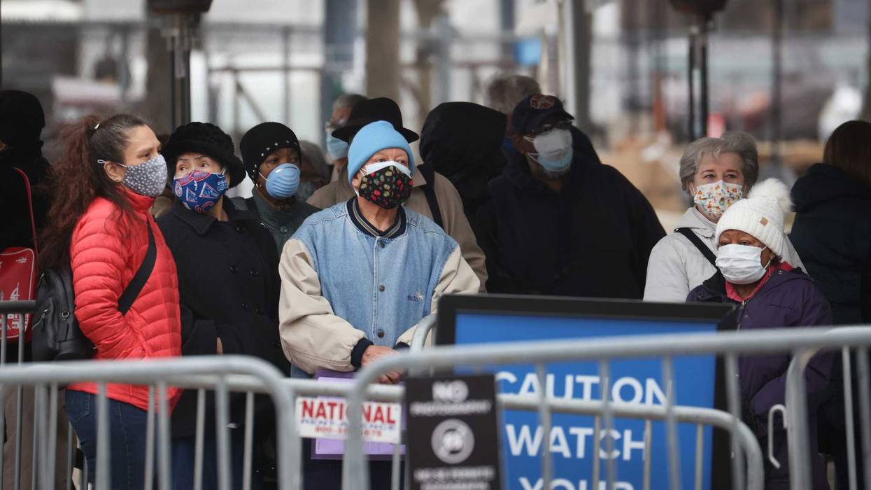 Residents wait in line to be vaccinated at a mass COVID-19 vaccination center set up in a parking lot outside of the United Center, home to the Chicago Bulls and Blackhawks, on March 10, 2021 in Chicago, Illinois. The site, which opened at full capacity today, expects to vaccinate 6,000 residents-per-day.
