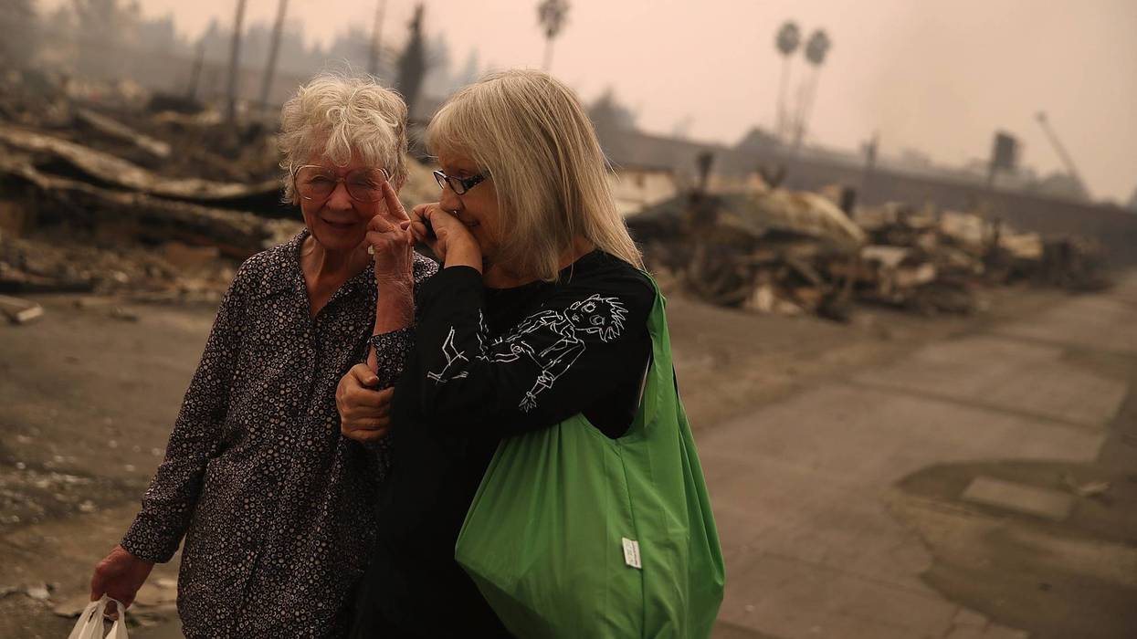 Residents walk through the fire damaged Journey's End Mobile Home Park on October 9, 2017 in Santa Rosa, California.