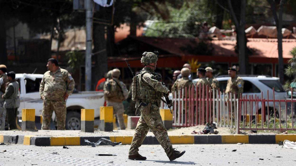 Resolute Support (RS) forces and Afghan security personnel inspect the site of a car bomb explosion in Kabul, Afghanistan, Thursday, Sept. 5, 2019.