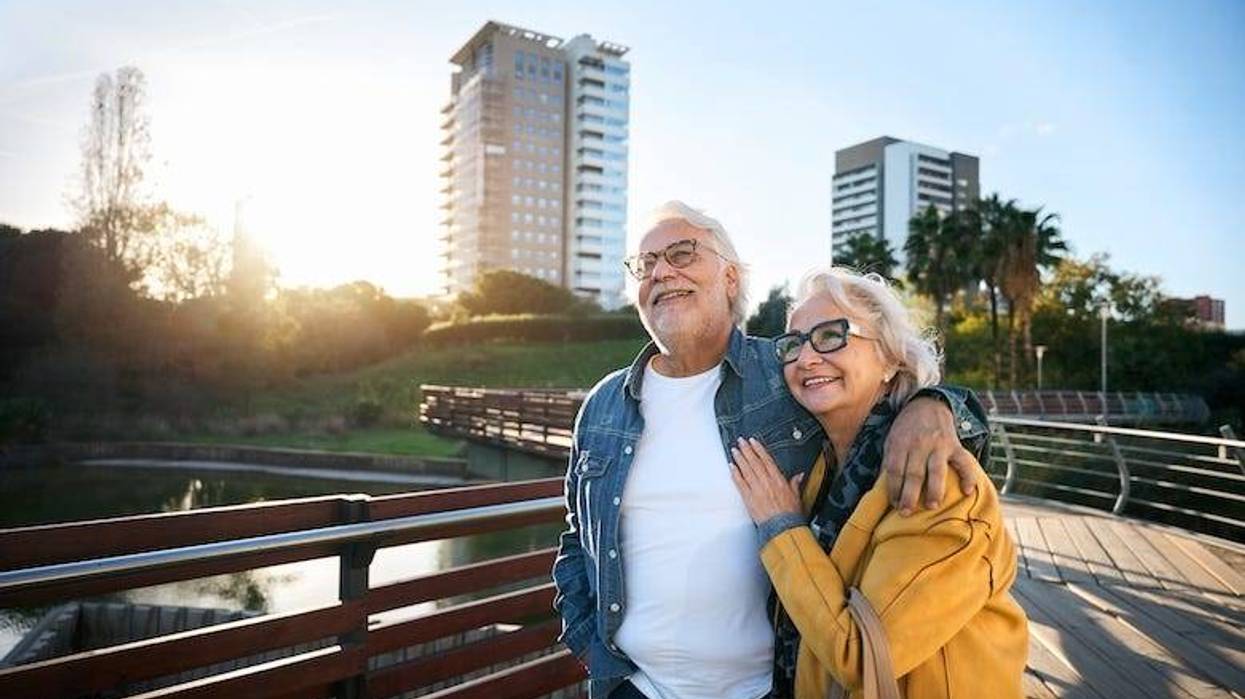Retired couple walking on a bridge