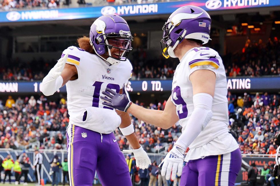 Reunited after two seasons in Carolina, Adam Thielen #19 as a Minnesota Viking celebrates with Justin Jefferson #18 after a touchdown in the first quarter of a game against the Chicago Bears at Soldier Field on January 08, 2023 in Chicago, Illinois.