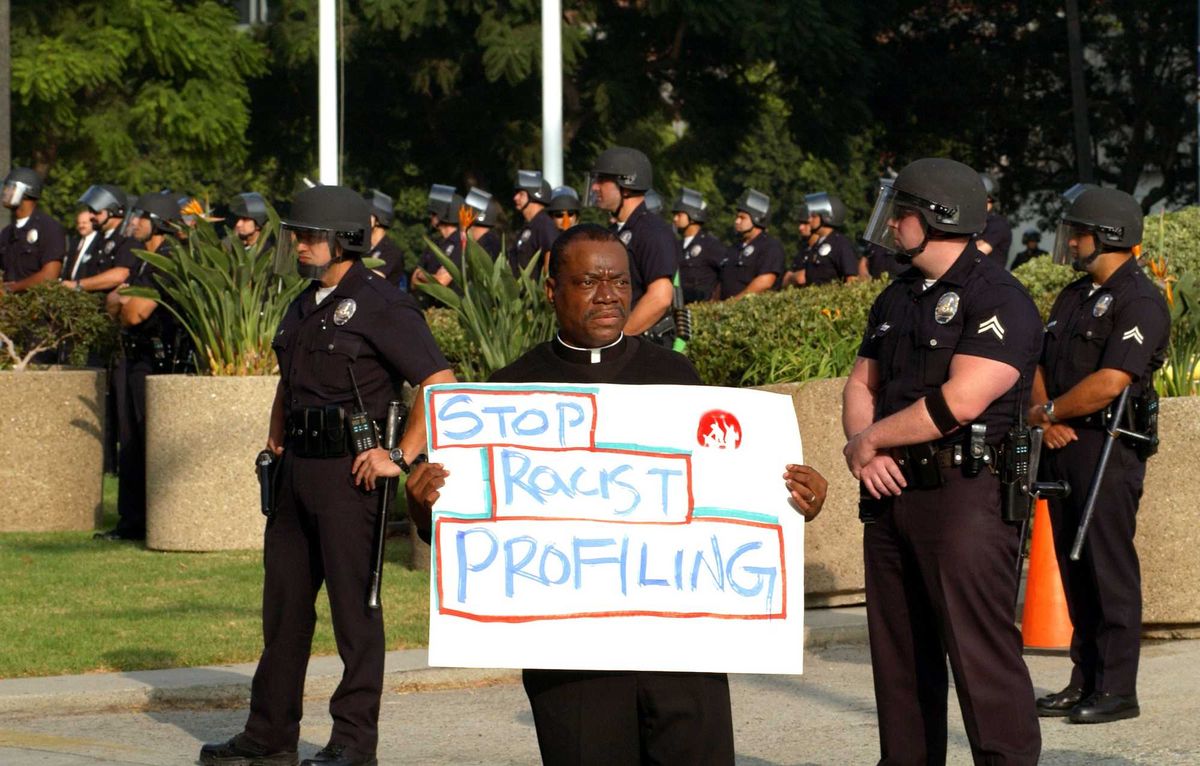Rev. M. Andrew Robinson-Gaither protests against racial profiling at the sixth annual national protest against police brutality.