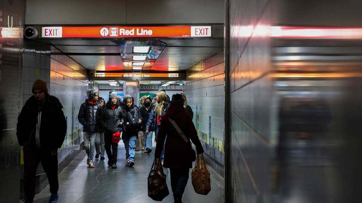Riders walk to and from the Red Line stop in the Roosevelt CTA station on Dec. 19, 2023, in Chicago.