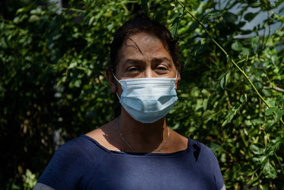 Rina Miller, who lost her son to COVID-19, poses for a picture outside her home in the Lawndale neighborhood, Tuesday morning, Aug. 24, 2021.