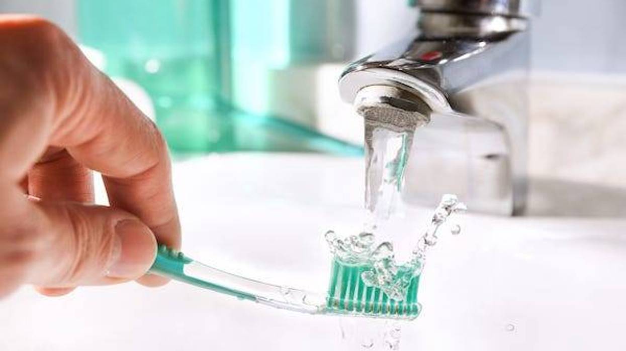 Rinsing toothbrush under the faucet