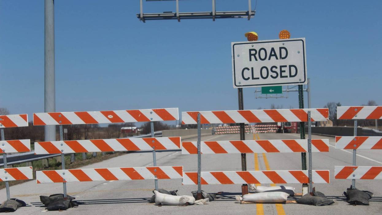 Road Closed barricades for through traffic over bridge.