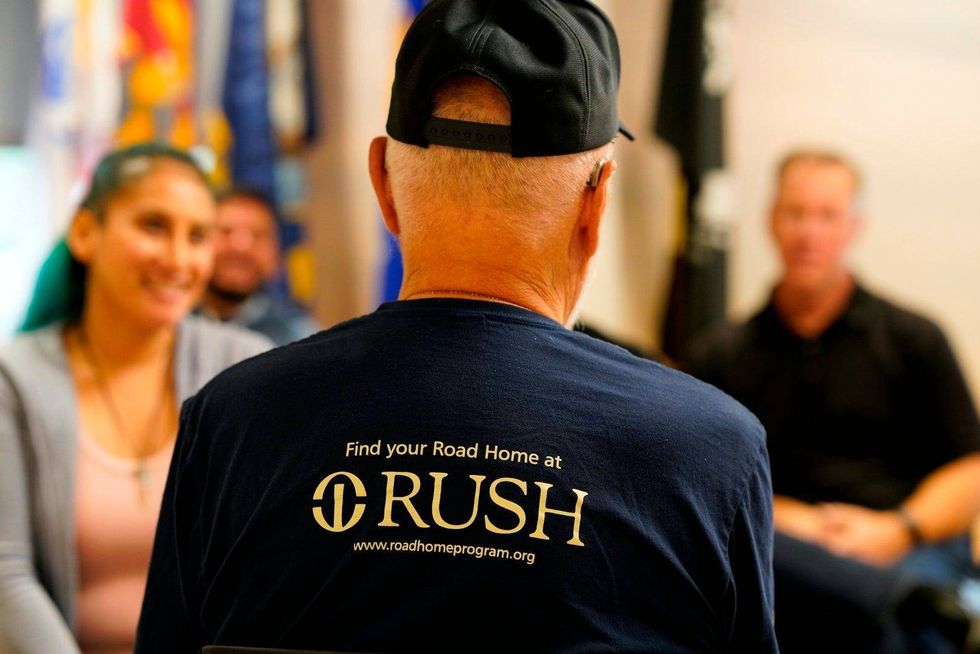 Road Home Program participants sit and talk to one another.