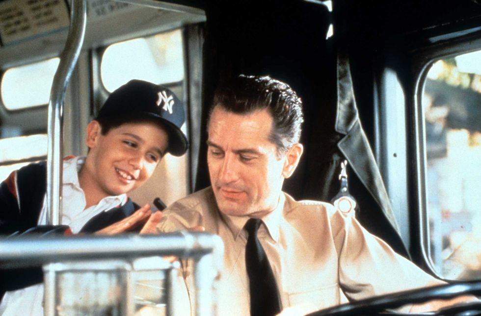 Robert De Niro driving a bus while talking with a young boy in a scene from the film