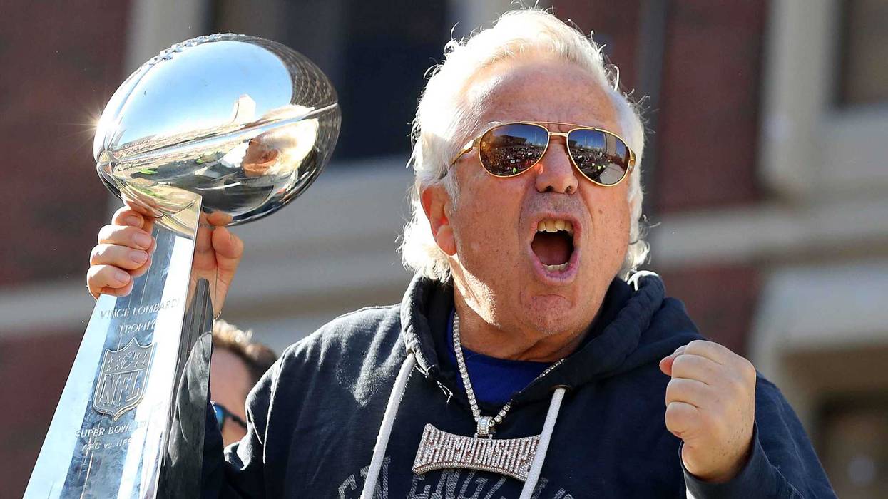 Robert Kraft holds the Lombardi Trophy aloft at the New England Patriots' Super Bowl parade in 2019.